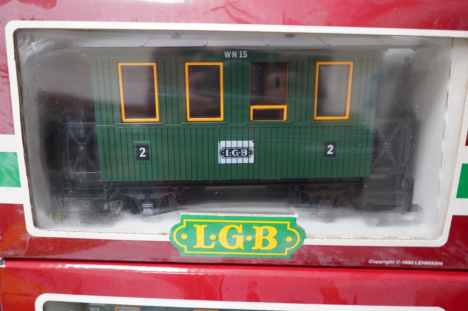 Four boxed Lehmann LGB G scale coaches; a bogie coach (3060), and three 4-wheel coaches (3106 and 2x 3050). Condition - good.